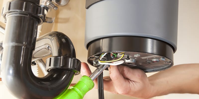 Technician repairing the heating element of a water heater in Roswell